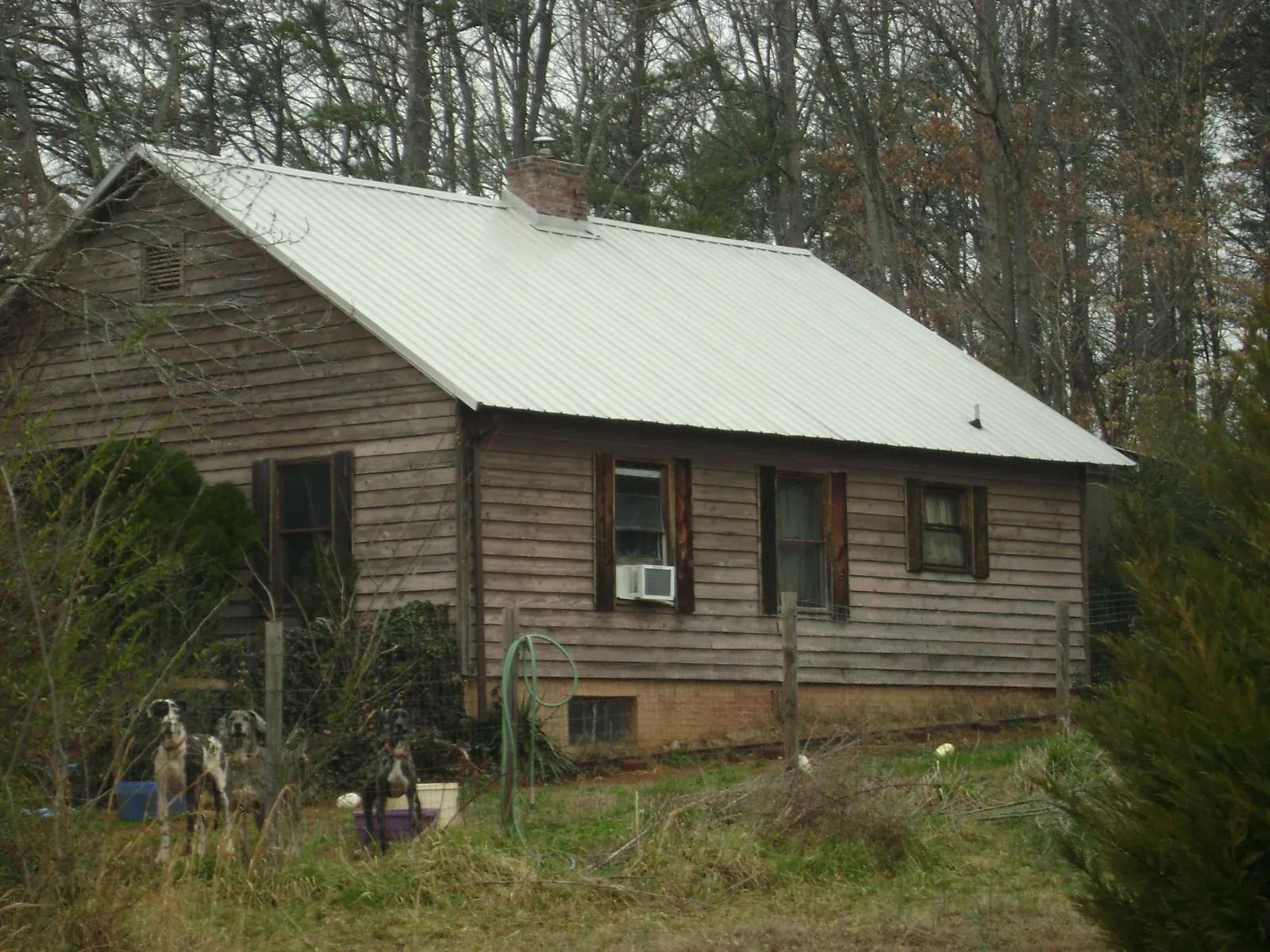 White metal roof on an old wood sided farmhouse, from a Metal Roof Installation job in West Salem